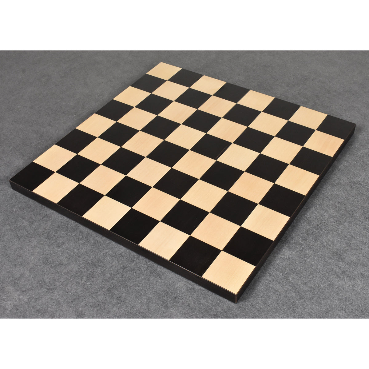 Full top-down view of a classic ebony and maple wood chess board square pattern.