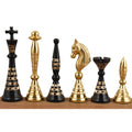 Lineup of black and gold solid brass Warli tribal chess pieces showcasing intricate traditional carvings.