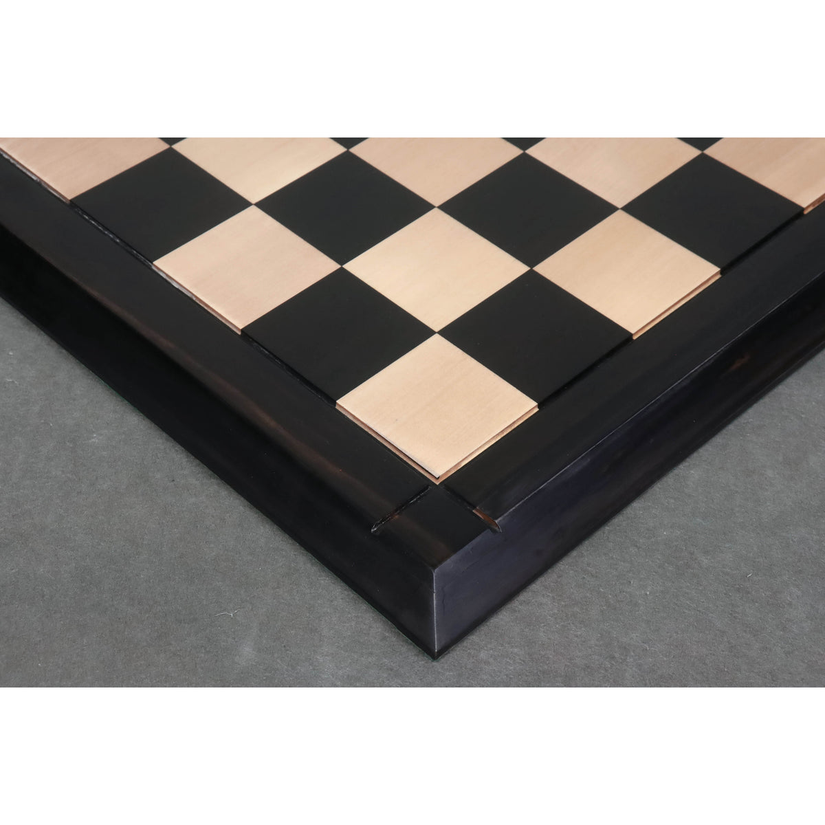 Detailed side view showing the thick ebony and maple wood blocks of the Drueke style board.