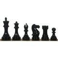 Six polished black lacquered wooden chess pieces standing in a row from King to Pawn.