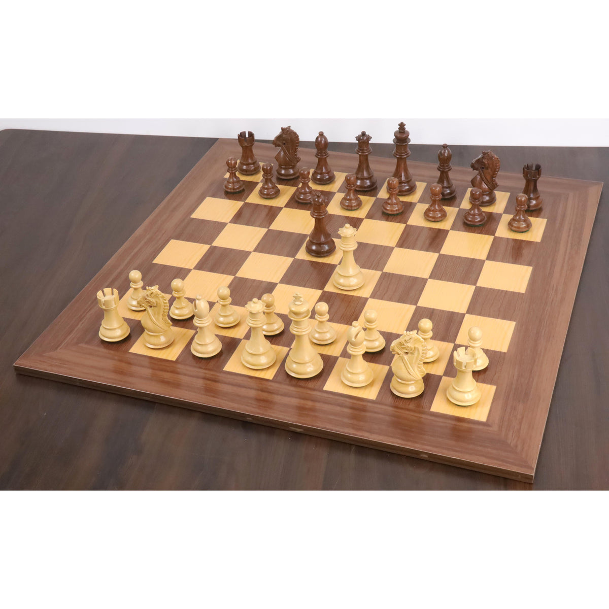 Complete 4 inch Bridle Staunton luxury chess set arranged on a matching wooden chessboard.