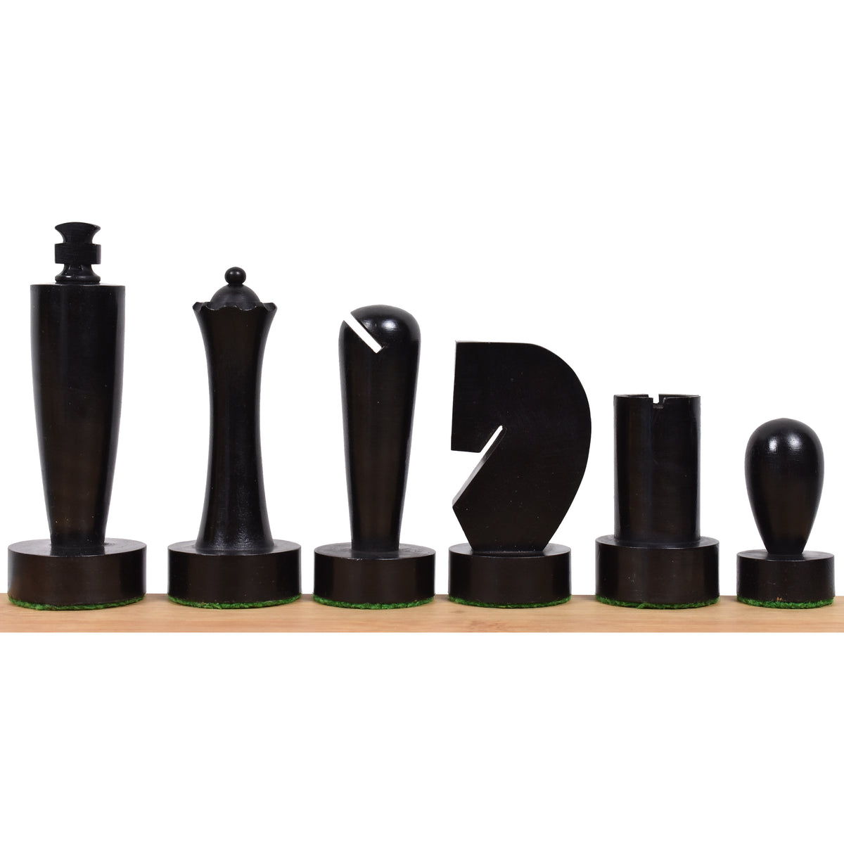 Modern minimalist ebonised boxwood chess pieces from the Berliner series lined up on a wooden base.