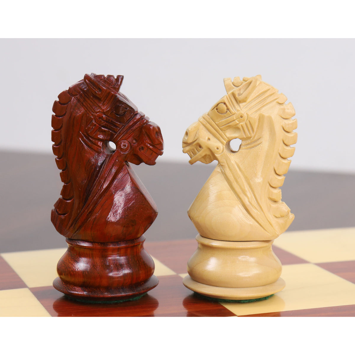 Finely carved knights from the Bridle Staunton luxury chess set in contrasting bud rosewood and boxwood.