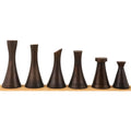 Six antique brass finished luxury metal chess pieces showcasing the modern Tower Series design.