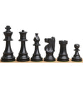 Dark antiqued boxwood Improved French Lardy chess pieces arranged in a row.