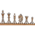A side-by-side view of the complete set of polished silver brass chess pieces, highlighting their metallic luster and detailed craftsmanship.