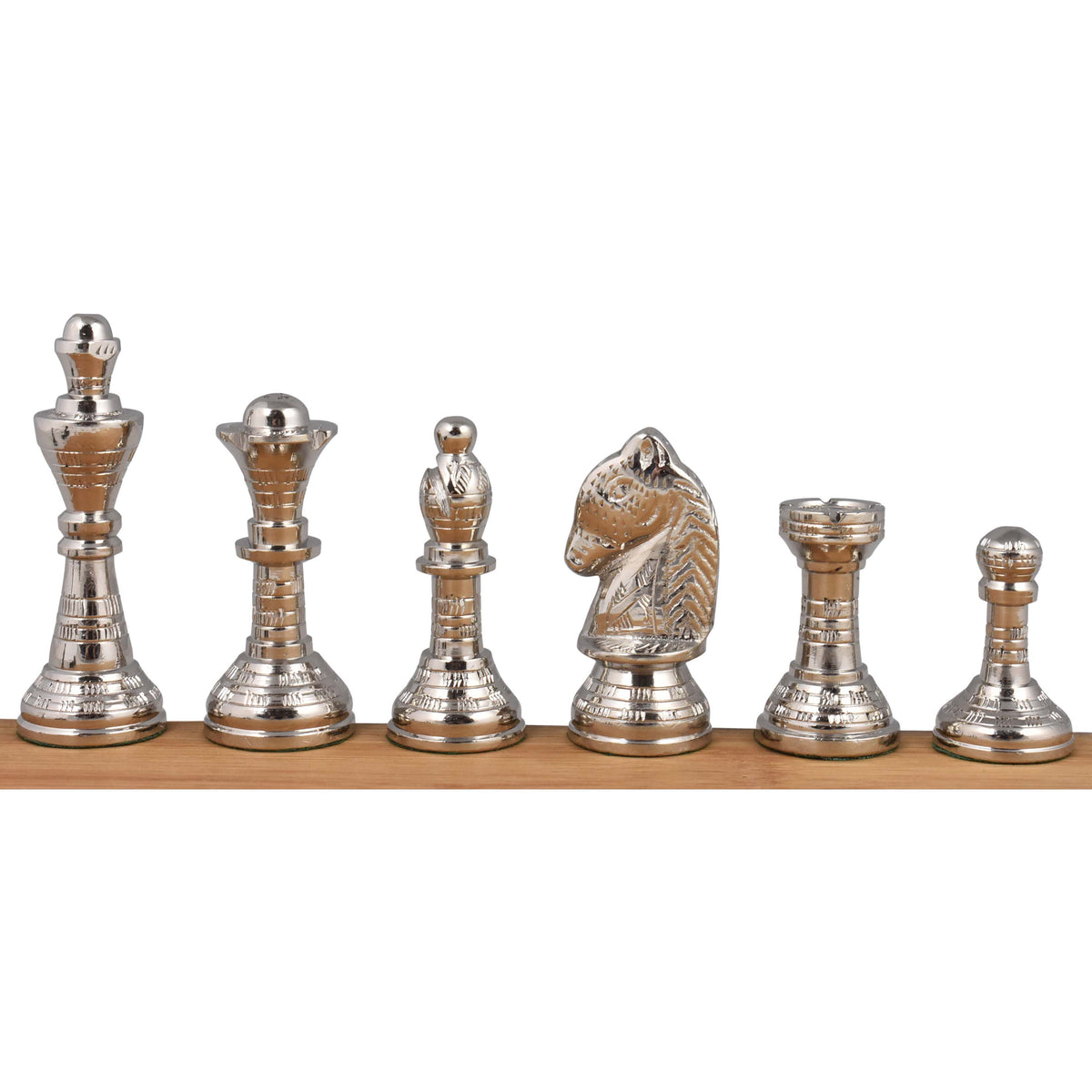 A side-by-side view of the complete set of polished silver brass chess pieces, highlighting their metallic luster and detailed craftsmanship.
