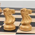 Close-up profile of two carved natural boxwood knights from the Soviet Großmeister Supreme set on a wooden chessboard.