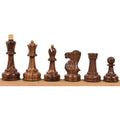 Dark golden rosewood pieces of the Soviet Großmeister Supreme chess set displayed in a line.