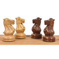 Two golden rosewood and two boxwood knights from the Soviet Großmeister Supreme set showing intricate carvings.