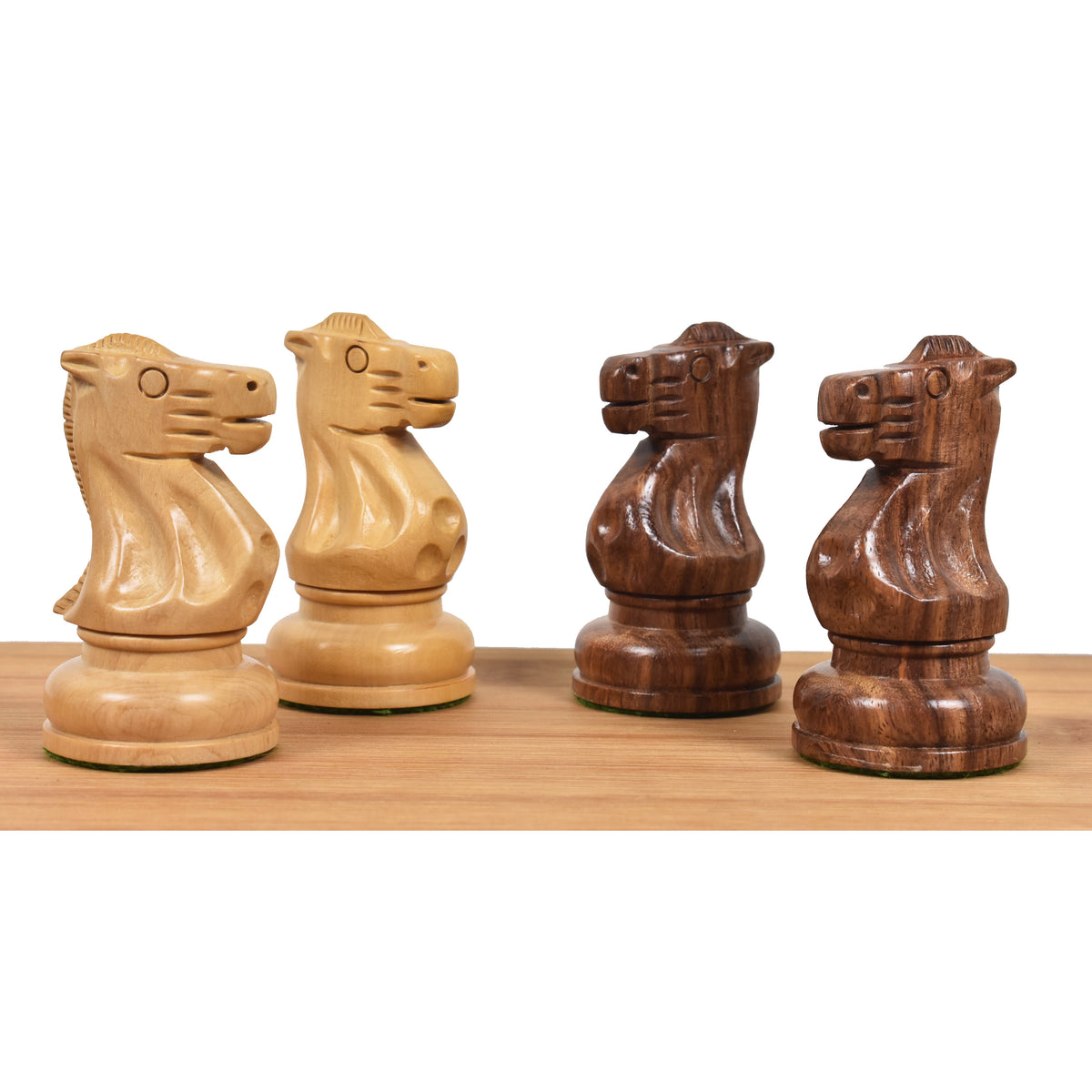 Two golden rosewood and two boxwood knights from the Soviet Großmeister Supreme set showing intricate carvings.