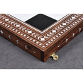 Detailed view of the corner construction and polished brass latches of a luxury 24-inch folding wooden chess board.