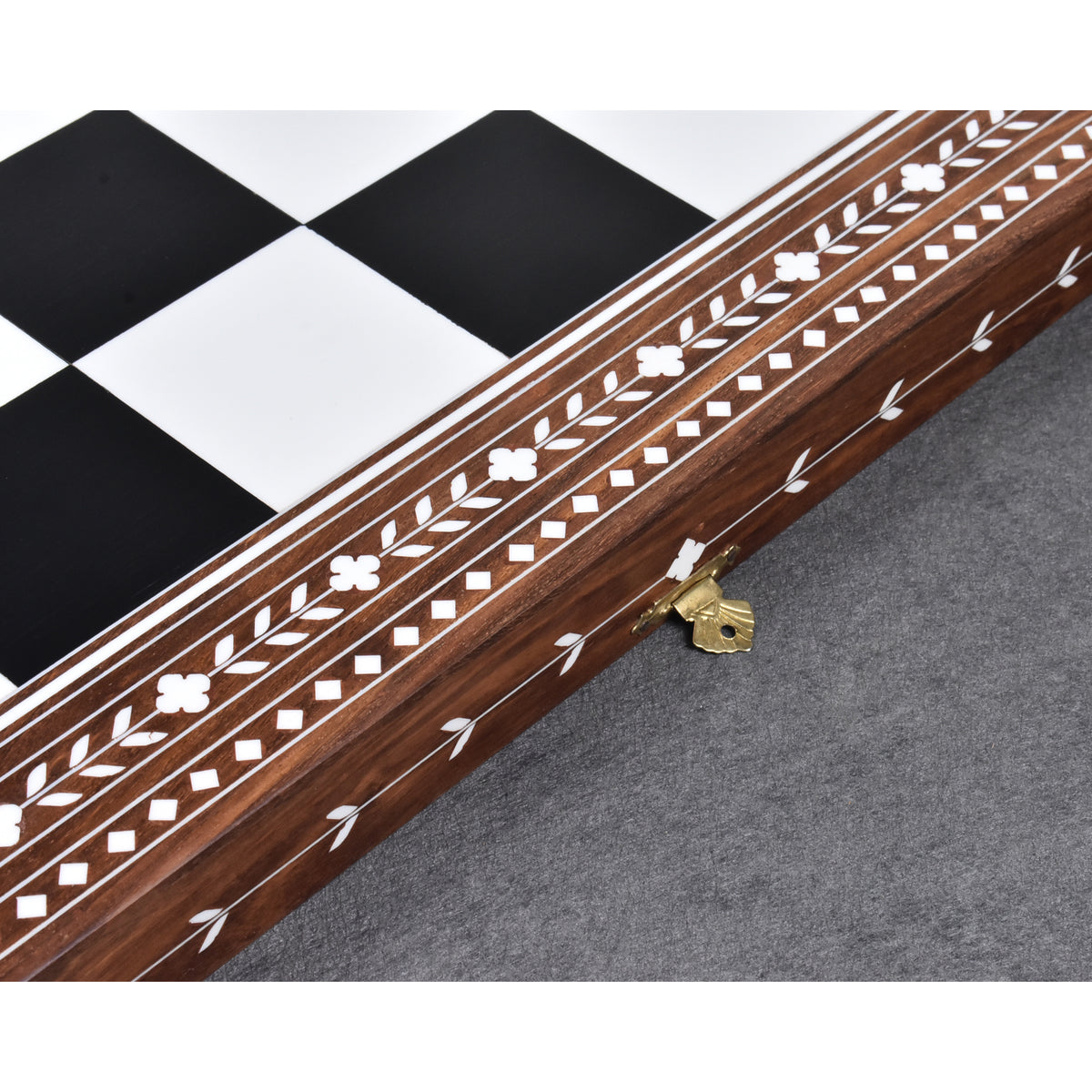 Side profile showcasing the wood grain and continuous floral inlay pattern on a 24-inch Rosewood folding board.