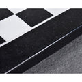 Macro detail of the polished black and white marble chessboard border.