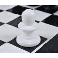 Macro shot of a single white marble pawn on the stone chessboard.