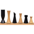 Mixed ebonized and boxwood 3.4" Minimalist Tower chess pieces arranged by height on a wooden ledge.