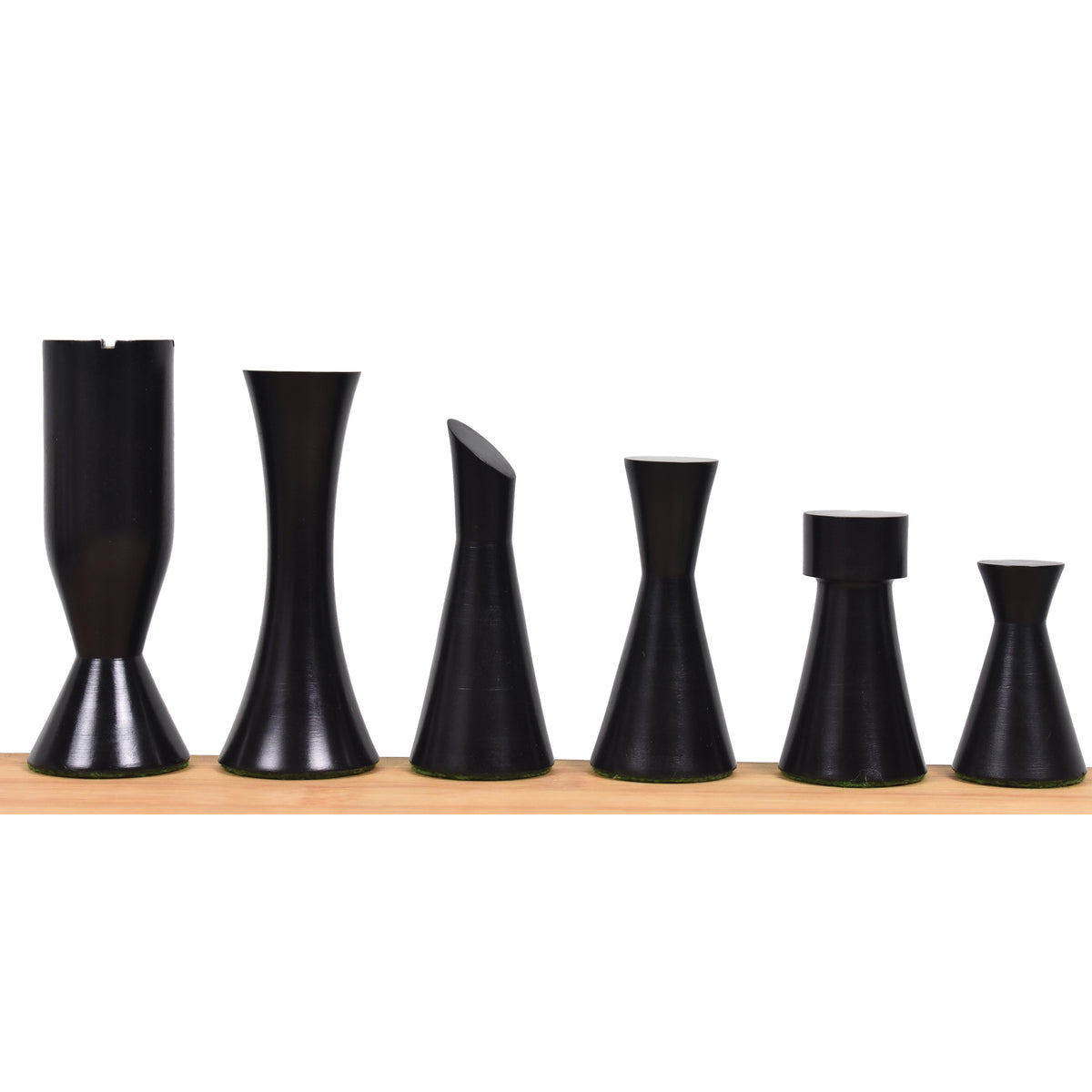 Six black ebonized boxwood Minimalist Tower chess pieces arranged by descending height.