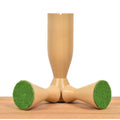 Three boxwood Minimalist Tower chess pieces displaying their protective green felt weighted bases.