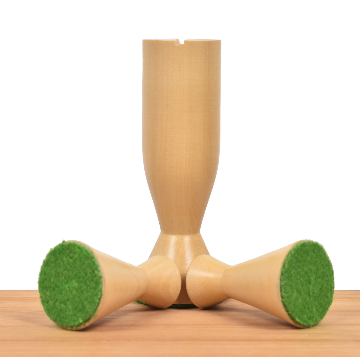 Three boxwood Minimalist Tower chess pieces displaying their protective green felt weighted bases.