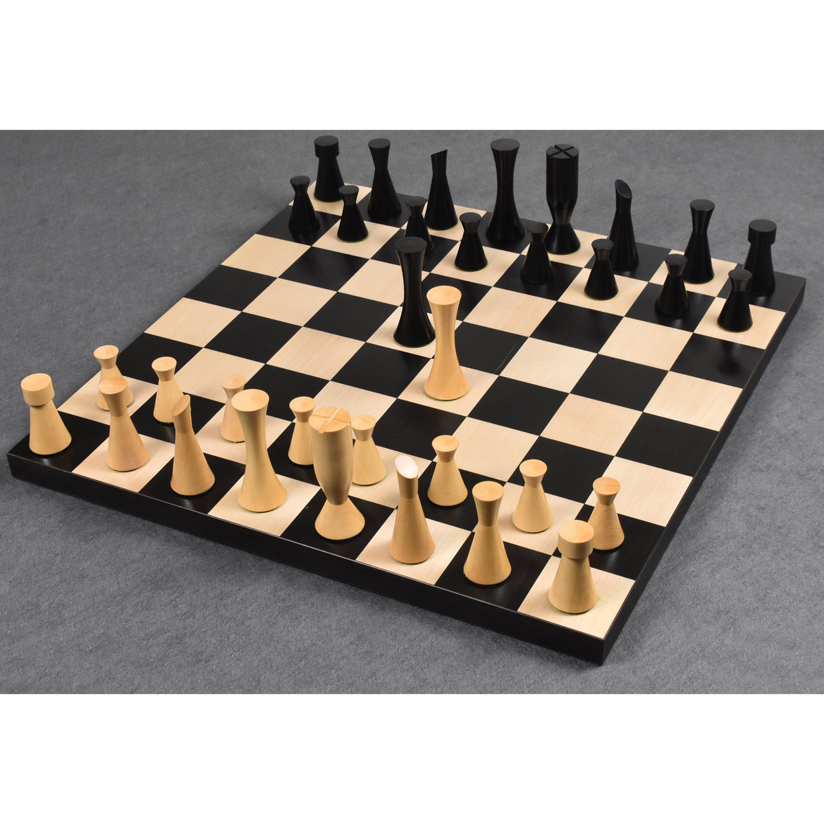 Complete set of 3.4" Minimalist Tower chess pieces set up for play on a black and white chessboard.