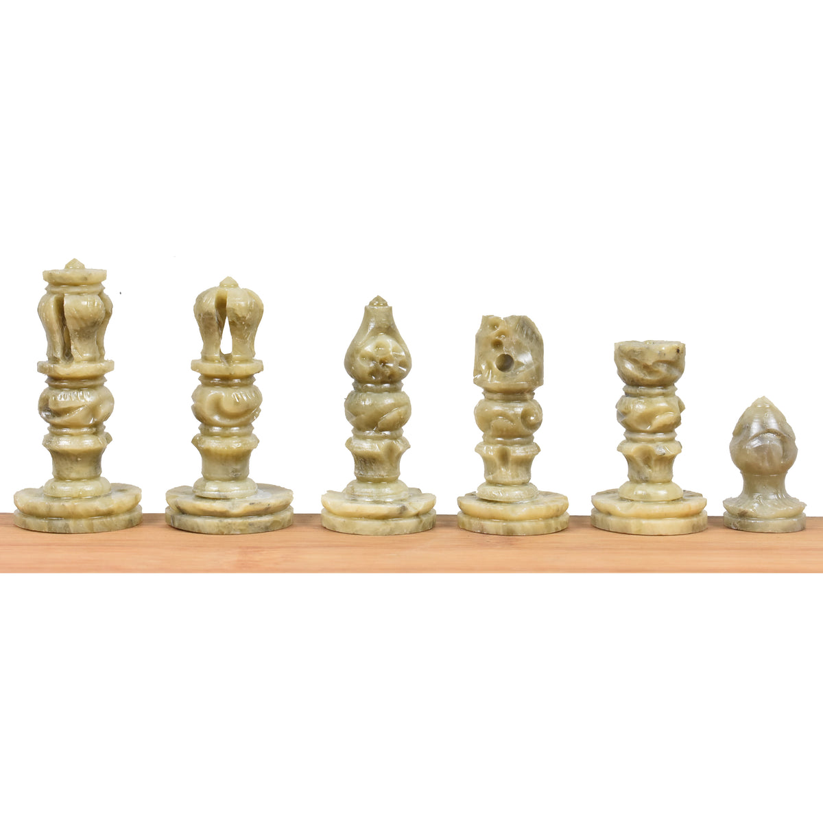 Lineup of handcarved green soapstone chess pieces showcasing king, queen, bishop, knight, rook, and pawn.