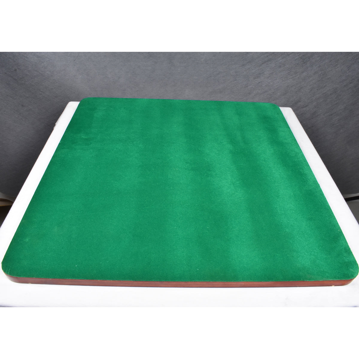 Premium wooden chessboard featuring a protective green felt base for surface safety.