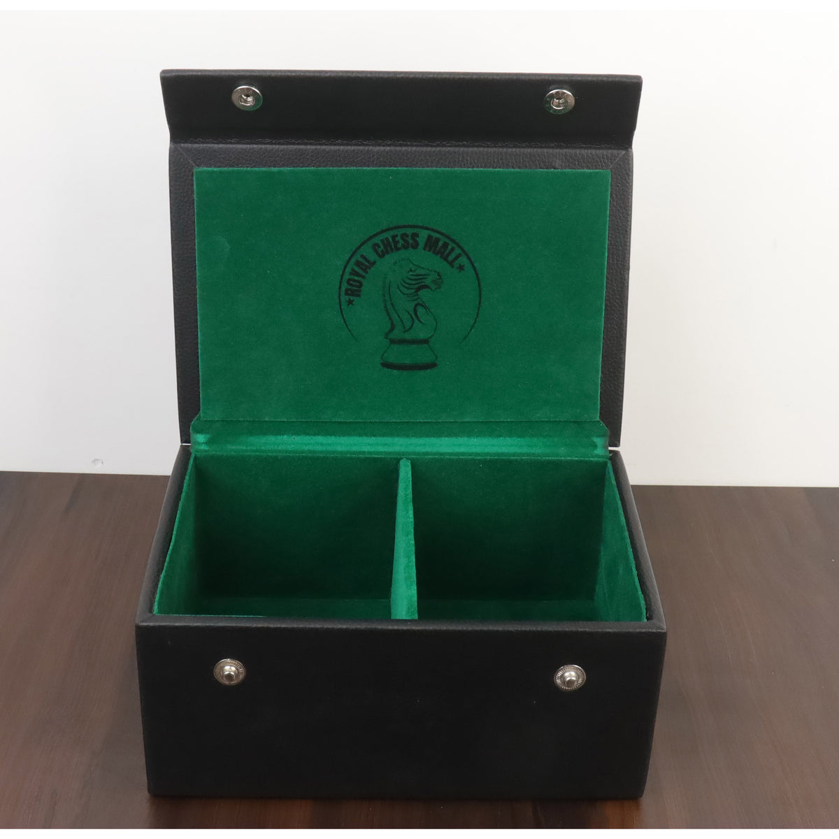 Open black leatherette chess storage box featuring green felt interior and brand logo.