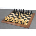 Full set of 3.8" Imperial Staunton ebony chess pieces set up on a wooden chessboard with the white queen advanced.