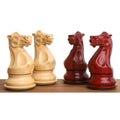 Four hand-carved sleek Staunton chess knights in bud rosewood and boxwood facing each other.