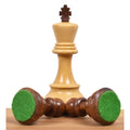 Boxwood king piece standing behind two golden rosewood pieces showing green felted bases.