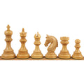 Light boxwood Staunton chess pieces lined up in a row.