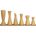 Natural boxwood light pieces of the Minimalist Tower Series chess set, beautifully lined up in descending height order.