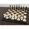 Turkish Tower pre-Staunton chess set arranged on a wooden chessboard