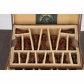 Wooden chess pieces securely organized inside the tan brown leatherette coffer storage box slots.