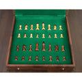 Magnetic wooden chess pieces stored inside 10-inch travel set.