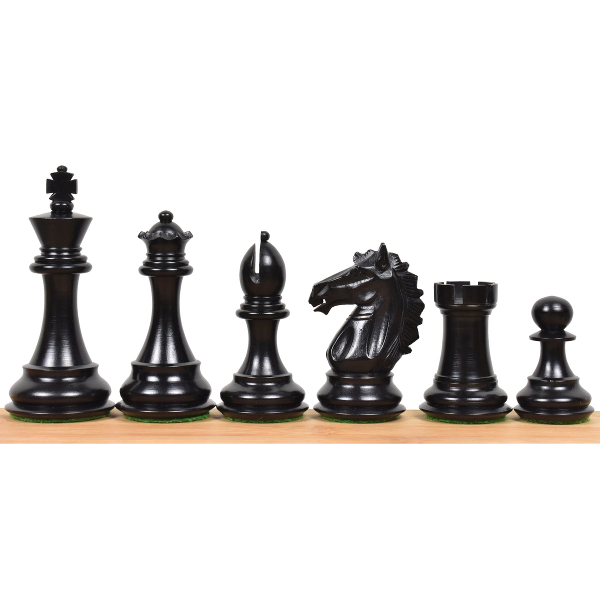 Dark ebony wood Alban Staunton chess pieces lined up from king to pawn on a wooden surface.
