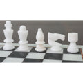 Close-up of handcarved white marble chess pieces on a 12-inch board.