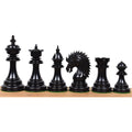 Polished dark ebony wood chess pieces from the 4.4 inch Dragon Luxury Staunton collection arranged in a row.