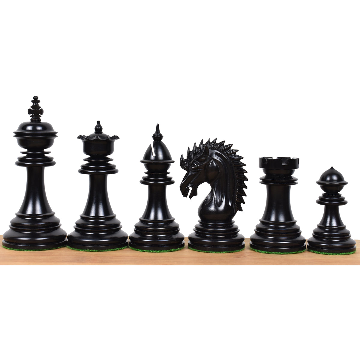 Polished dark ebony wood chess pieces from the 4.4 inch Dragon Luxury Staunton collection arranged in a row.