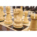 Close-up shot of a boxwood Leningrad Staunton knight on a wooden chessboard.