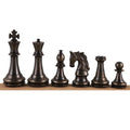 Antique finish luxury brass metal chess pieces with detailed craftsmanship on a wooden rail.