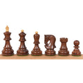 Weighted Golden Rosewood chess pieces in the Russian Zagreb style lined up against white.