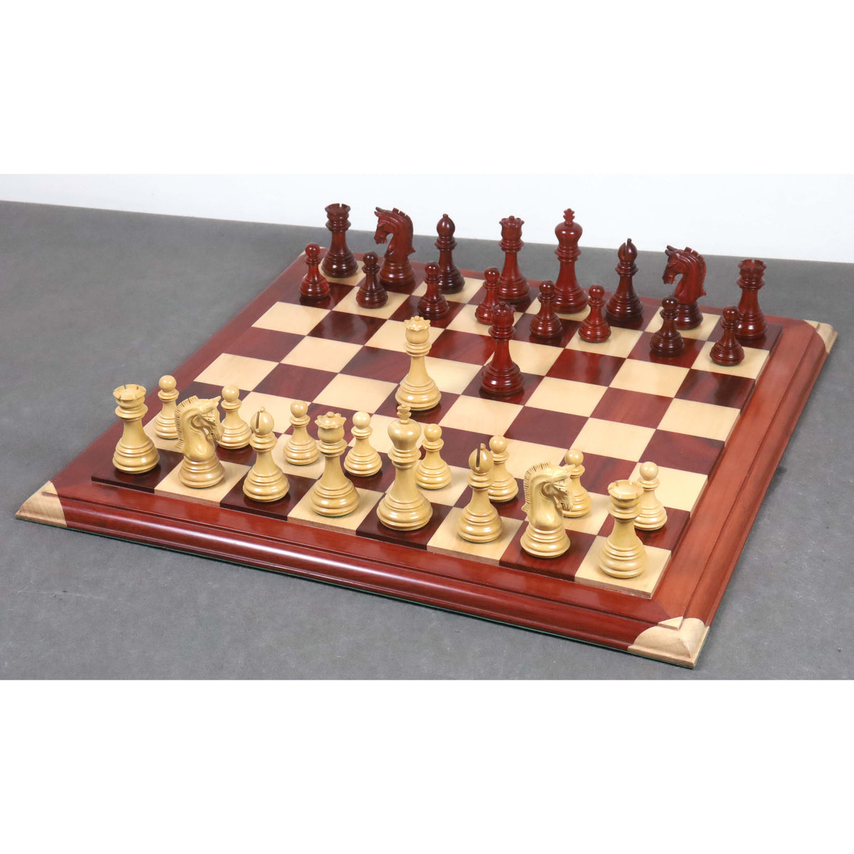 3.8" Imperial Staunton chess pieces in bud rosewood and boxwood arranged in starting position.