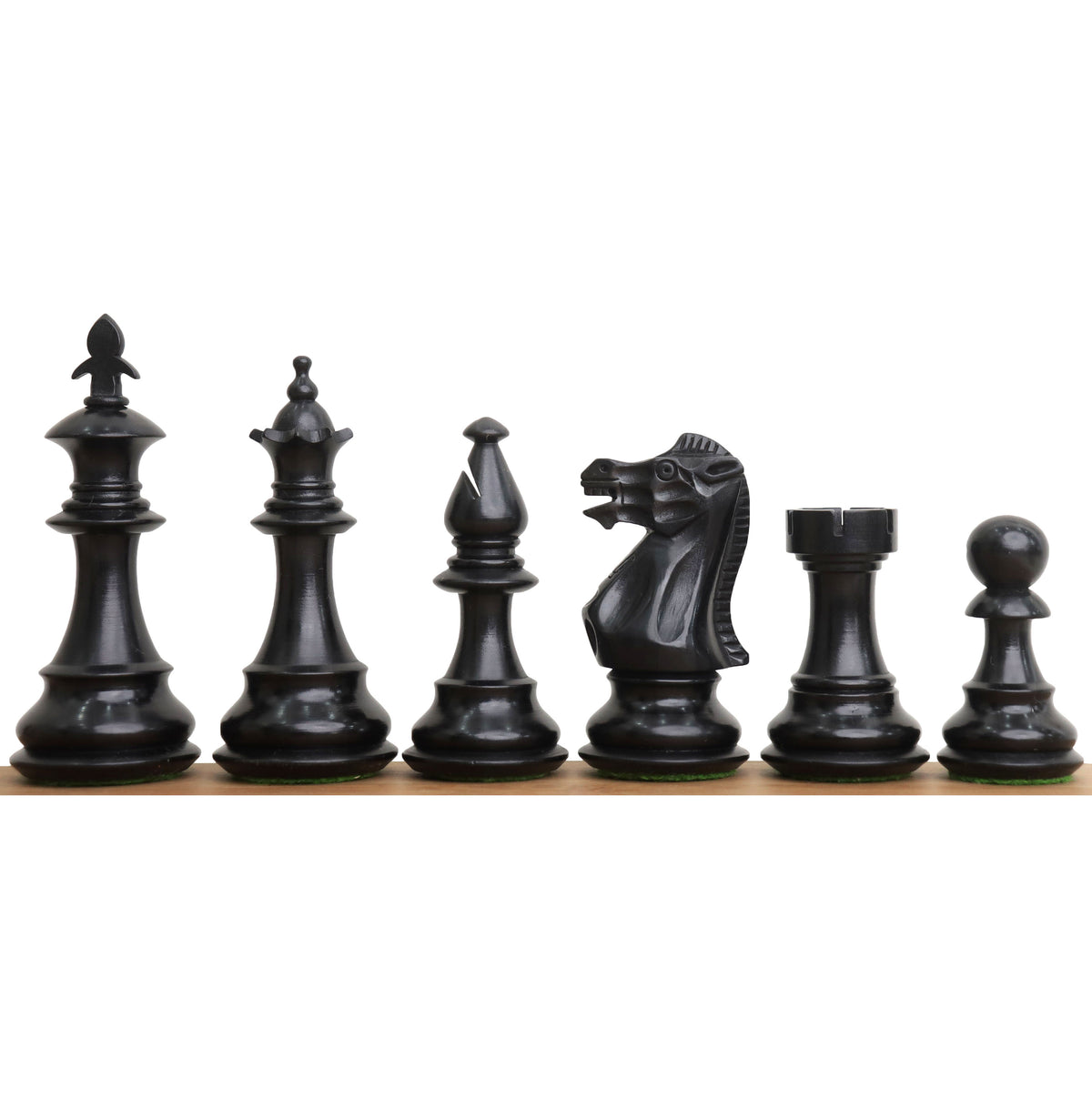 Black ebonised pieces of the 3.7" British Staunton weighted chess set arranged from king to pawn.