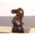 Close-up profile of a triple weighted rosewood knight chess piece showing detailed mane and facial carving.