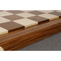 Side profile view of a luxury chessboard highlighting the raised playing surface and carved Golden Rosewood border.