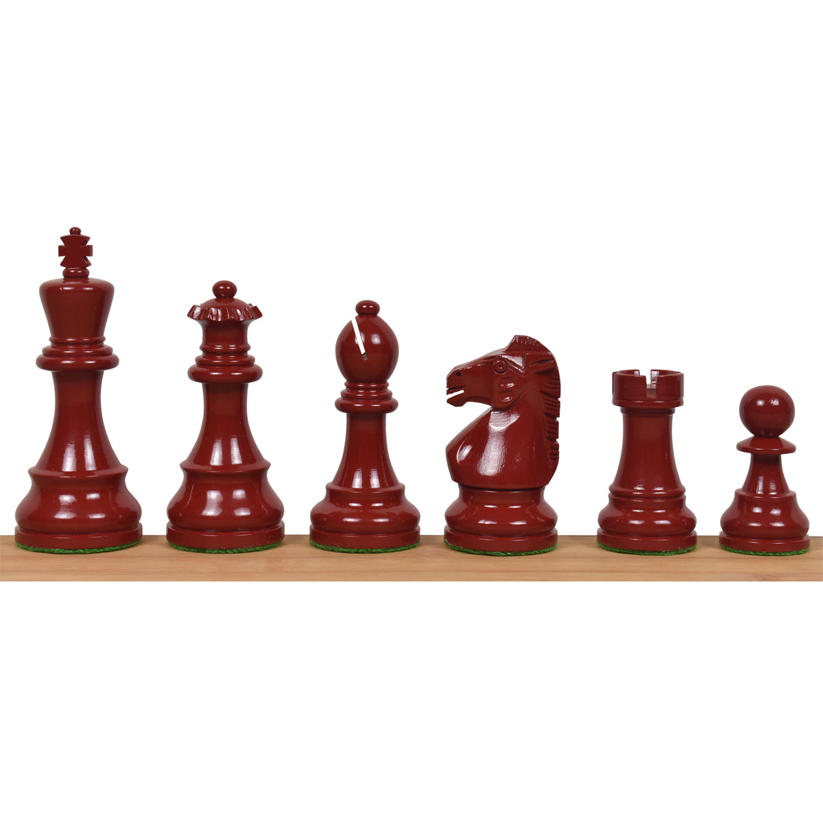 Full set of burgundy lacquered boxwood Prime Staunton chess pieces arranged from king to pawn on a wooden surface.