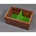 Top-down interior view of the golden rosewood chess storage box with green felt divider compartments.