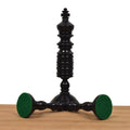 Black antique pre-Staunton king chess piece featuring a detailed felt base.