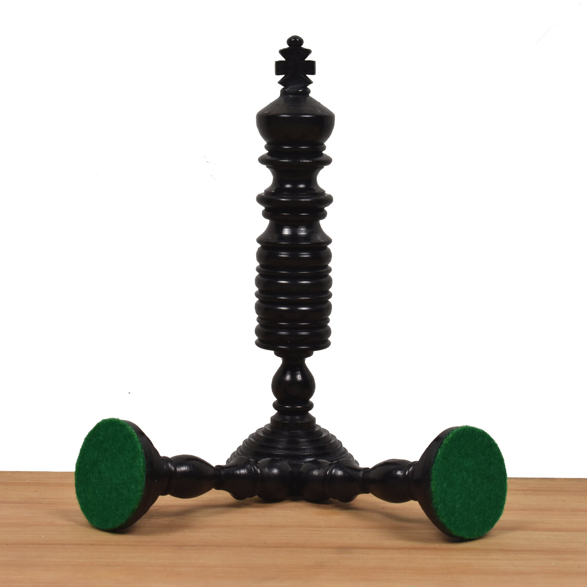 Black antique pre-Staunton king chess piece featuring a detailed felt base.